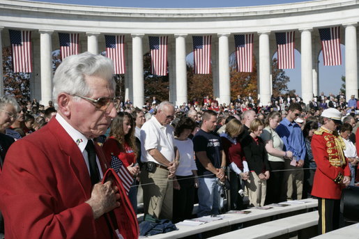 Veterans and invited guests stand in remembrance at Veteran’s Day ceremonies Saturday, Nov. 11, 2006, at Arlington National Cemetery in Arlington, Va., where President George W. Bush lay a wreath at the Tomb of the Unknowns, and addressed veterans, their family members and guests. White House photo by Kimberlee Hewitt