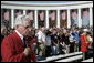 Veterans and invited guests stand in remembrance at Veteran’s Day ceremonies Saturday, Nov. 11, 2006, at Arlington National Cemetery in Arlington, Va., where President George W. Bush lay a wreath at the Tomb of the Unknowns, and addressed veterans, their family members and guests. White House photo by Kimberlee Hewitt