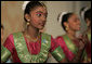 A student from the Bukit View Primary School in Singapore performs a cultural dance with classmates for President George W. Bush and Mrs. Laura Bush during their visit Thursday, Nov. 16, 2006, to the city's Asian Civilisations Museum. White House photo by Paul Morse