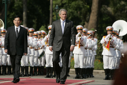 President George W. Bush and Viet President Nguyen Minh Triet review the honor guard Friday, Nov. 17, 2006, during the arrival ceremony at the Presidential Palace in Hanoi. White House photo by Paul Morse