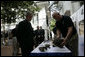 Forensic archaeologist Dr. Bradley Sturm briefs President George W. Bush during a visit Saturday, Nov. 18, 2006, to the POW/MIA Accounting Command in Hanoi. White House photo by Eric Draper