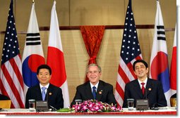 President George W. Bush sits with President Roh Moo-Hyun, of the Republic of Korea, left, and Japan's Prime Minister Shinzo Abe during a trilateral discussion Saturday, Nov. 18, 2006, at the Sheraton Hanoi hotel in Hanoi, where they are participating in the Asia Pacific Economic Cooperation summit. White House photo by Eric Draper