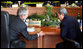 President Bush leans in to talk with Prime Minister Surayud Chulanont of Thailand during the first retreat of APEC leaders Saturday, Nov. 18, 2006, at the National Conference Center in Hanoi. White House photo by Eric Draper