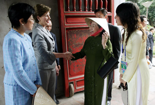 Mrs. Laura Bush is greeted as she arrives at the Temple of Literature in Hanoi Saturday, Nov. 18, 2006, for a tour with the spouses of APEC leaders. White House photo by Shealah Craighead