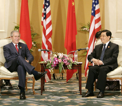 President George W. Bush and President Hu Jintao of China pause for photos after their bilateral talks Sunday, Nov. 19, 2006, at the Hanoi Daewoo Hotel in Hanoi. White House photo by Eric Draper