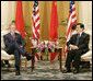 President George W. Bush and President Hu Jintao of China pause for photos after their bilateral talks Sunday, Nov. 19, 2006, at the Hanoi Daewoo Hotel in Hanoi. White House photo by Eric Draper