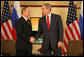 President George W. Bush and President Vladimir Putin of Russia exchange handshakes Sunday, Nov. 19, 2006, at the Sheraton Hanoi after their two countries signed agreements supporting Russia's accession into the World Trade Organization. Said President Bush afterward, "This is a good agreement for the United States. And it's an equally important agreement for Russia. And it's a good agreement for the international trading community." White House photo by Eric Draper