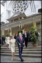 President George W. Bush and Mrs. Laura Bush leave the Cua Bac Church in Hanoi Sunday, Nov. 19, 2006, following morning services. The President stopped for a brief statement afterward during which he said, "A whole society is a society which welcomes basic freedom, and there's no more basic freedom than the freedom to worship." White House photo by Eric Draper