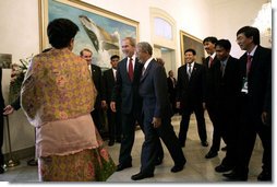 President George W. Bush greets participants as he heads to a roundtable discussion Monday, Nov. 20, 2006, at the Bogor Palace in Bogor, Indonesia. White House photo by Eric Draper