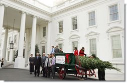 Mrs. Laura Bush stands with the Botek family of Lehighton, Pa., as she receives the official White House Christmas tree on the North Portico Monday, Nov. 27, 2006. The Botek family owns Crystal Springs Tree Farm and donated the 18-foot Douglas fir tree. White House photo by Shealah Craighead