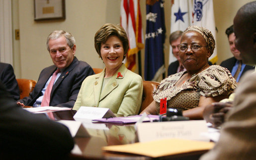 President George W. Bush and Laura Bush speak with their guests at a meeting on World AIDS Day in the Roosevelt Room at the White House, Friday, Dec. 1, 2006, who support the President’s Emergency Plan for AIDS Relief (PEPFAR), which is the largest international health initiative in history dedicated to a single disease. Angelina Magaga, Center Coordinator for the Light and Courage Center Trust in Botswana, Africa, is seen at right. White House photo by Eric Draper