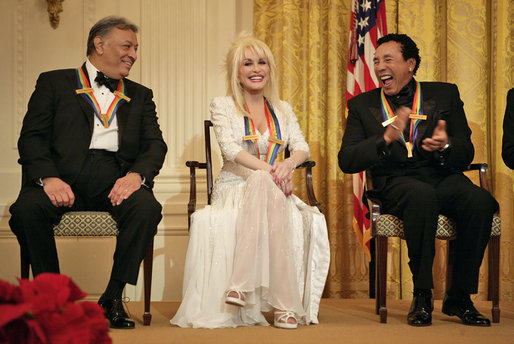 Conductor Zubin Mehta laughs with singers Dolly Parton and William "Smokey" Robinson during a reception for the Kennedy Center honorees in the East Room Sunday, Dec. 3, 2006. White House photo by Eric Draper