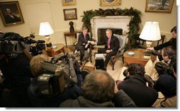 President George W. Bush exchanges handshakes with U.N. Ambassador John Bolton during his visit Monday, Dec. 4, 2006, to the White House. Earlier, upon announcement of the Ambassador's resignation, the President said in a statement, "It is with deep regret that I accept John Bolton's decision to end his service." White House photo by Eric Draper