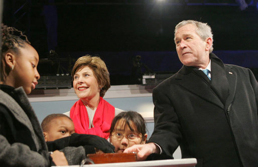 President George W. Bush and Laura Bush are joined by Junior Rangers from the National Park Service program Thursday evening, Dec. 7, 2006, as they press the switch to light the National Christmas Tree on the Ellipse in Washington, D.C. White House photo by Kimberlee Hewitt