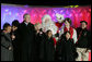 President George W. Bush and Laura Bush join entertainers Eartha Kitt, left, and Cathy Rigby, center, along with Santa Claus, invited children and The Singing Angels choir director Charles Eversole, right, on stage Thursday, Dec. 7, 2006, at the 2006 Christmas Pageant of Peace and the 83rd lighting of the National Christmas Tree on the Ellipse in Washington, D.C. White House photo by Kimberlee Hewitt