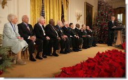 President George W. Bush looks back as he addresses the 2006 recipients of the Presidential Medal of Freedom on stage in the East Room of the White House Friday, Dec. 15, 2006. Said the President, "The Presidential Medal of Freedom is our nation's highest civil honor. The medal recognizes high achievement in public service, science, the arts, education, athletics, and other fields. Today we honor 10 exceptional individuals who have gained great admiration and respect throughout our country." White House photo by Shealah Craighead