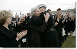 Joyce Rumsfeld, wife of Secretary of Defense Donald Rumsfeld, embraces General Peter Pace, Chairman of the Joint Chiefs of Staff, after she was presented with a medal in recognition of her service Friday, Dec. 15, 2006, during an Armed Forces Full Honor Review in honor of her husband. Mrs. Lynne Cheney looks on at left. White House photo by Eric Draper