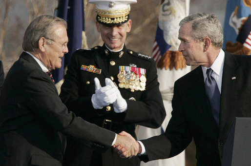 President George W. Bush and Secretary of Defense Donald Rumsfeld shake hands following President Bush's remarks honoring outgoing Secretary Rumsfeld during an Armed Forces Full Honor Review at the Pentagon Friday, Dec. 15, 2006, as Joint Chiefs of Staff Chairman General Peter Pace applauds. White House photo by Paul Morse