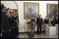 President George W. Bush and Laura Bush listen to Indiana University’s A Cappella Choir, HooShir, sing during the lighting of the Menorah during the annual White House Hanukkah reception Monday, Dec. 18, 2006. Pictured at right is Ariel Cohen, 14, and her parents Dan and Rachel Cohen. White House photo by Shealah Craighead