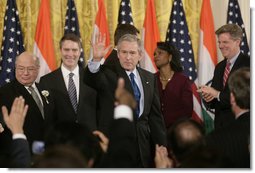 President George W. Bush acknowledges the applause of invited guests after signing H.R. 5682 The United States-India Peaceful Atomic Cooperation Act, Monday, Dec. 18, 2006, in the East Room of the White House. H.R. 5682 will allow the U.S. and India to share civilian nuclear technology and bring India’s civilian nuclear program under the safeguards of the International Atomic Energy Agency. White House photo by Kimberlee Hewitt