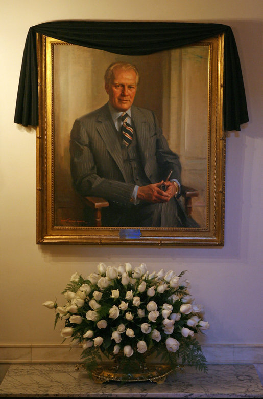 The portrait of former President Gerald R. Ford is draped with a black cloth in the Cross Hall of the White House Wednesday, Dec. 27, 2006. President Ford passed away Tuesday evening, Dec. 26. The portrait was painted by artist Everett Raymond Kinstler in 1977. 