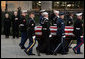 Vice President Dick Cheney and Mrs. Lynne Cheney salute as the casket of former President Gerald R. Ford is carried by a military honor guard during interment ceremonies on the grounds of the Gerald R. Ford Presidential Museum in Grand Rapids, Mich., Wednesday, January 3, 2007. White House photo by David Bohrer