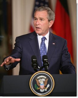 President George W. Bush gestures as he addresses his remarks during a joint news conference with German Chancellor Angela Merkel at the White House, Thursday, Jan. 4, 2006, discussing issues on security and peace in the Middle East, allied security efforts in Afghanistan and U.S.-European economic interest.  White House photo by Paul Morse