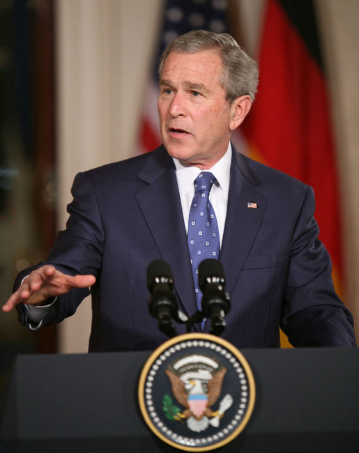 President George W. Bush gestures as he addresses his remarks during a joint news conference with German Chancellor Angela Merkel at the White House, Thursday, Jan. 4, 2006, discussing issues on security and peace in the Middle East, allied security efforts in Afghanistan and U.S.-European economic interest. White House photo by Paul Morse