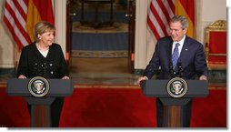 President George W. Bush and German Chancellor Angela Merkel react to a reporter’s question during a joint news conference at the White House, Thursday, Jan. 4, 2006, where they answered questions on Iraq, the Middle East and U.S.-European economic issues. White House photo by Paul Morse