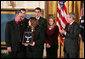 President George W. Bush presents the Medal of Honor to the family of Corporal Jason Dunham of the Marine Corps during a ceremony in the East Room Thursday, Jan. 11, 2007. The President spoke of Cpl. Dunham, "In April 2004, during an attack near Iraq's Syrian border, Corporal Dunham was assaulted by an insurgent who jumped out of a vehicle that was about to be searched. As Corporal Dunham wrestled the man to the ground, the insurgent rolled out a grenade he had been hiding. Corporal Dunham did not hesitate. He jumped on the grenade, using his helmet and body to absorb the blast. Although he survived the initial explosion, he did not survive his wounds. But by his selflessness, Corporal Dunham saved the lives of two of his men, and showed the world what it means to be a Marine."  White House photo by Paul Morse