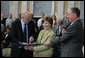 Mrs. Laura Bush is joined by U.S. Secretary of the Treasury Henry M. Paulson, Jr., left, and Richard C. Cote, curator, U.S. Department of the Treasury, as she cuts the ceremonial ribbon to mark the completion of the first major restoration at the U.S. Treasury Building, Thursday, Jan. 11, 2007, in Washington, D.C. White House photo by Shealah Craighead