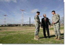 President George W. Bush speaks with base commander U.S. Army Maj. Gen. Walter Wojdakowski, right, and deputy base commander Colonel Mike Linnington, left, Thursday, Jan. 11, 2006, during a demonstration of airborne infantry training at Fort Benning, Ga.  White House photo by Eric Draper