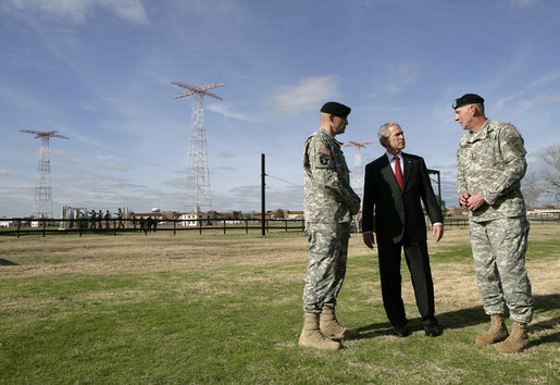 President George W. Bush speaks with base commander U.S. Army Maj. Gen. Walter Wojdakowski, right, and deputy base commander Colonel Mike Linnington, left, Thursday, Jan. 11, 2006, during a demonstration of airborne infantry training at Fort Benning, Ga. White House photo by Eric Draper