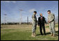 President George W. Bush speaks with base commander U.S. Army Maj. Gen. Walter Wojdakowski, right, and deputy base commander Colonel Mike Linnington, left, Thursday, Jan. 11, 2006, during a demonstration of airborne infantry training at Fort Benning, Ga. White House photo by Eric Draper