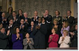 Dikembe Mutombo of the Houston Rockets is recognized by President George W. Bush during the State of the Union Address at U.S. Capitol Tuesday, Jan. 23, 2007. "Dikembe became a star in the NBA, and a citizen of the United States," said President Bush. "But he never forgot the land of his birth, or the duty to share his blessings with others. He built a brand new hospital in his old hometown. A friend has said of this good-hearted man: "Mutombo believes that God has given him this opportunity to do great things." And we are proud to call this son of the Congo a citizen of the United States of America."  White House photo by Eric Draper