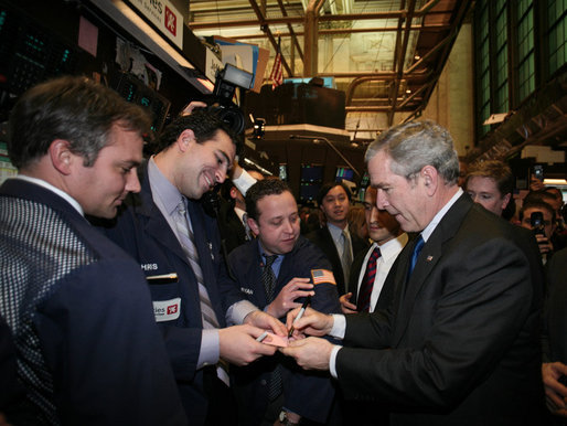 President George W. Bush signs autographs Wednesday, Jan. 31, 2007, during a surprise visit to the New York Stock Exchange. The visit marked only the second time a sitting president has visited the floor during regular Exchange hours. White House photo by Paul Morse