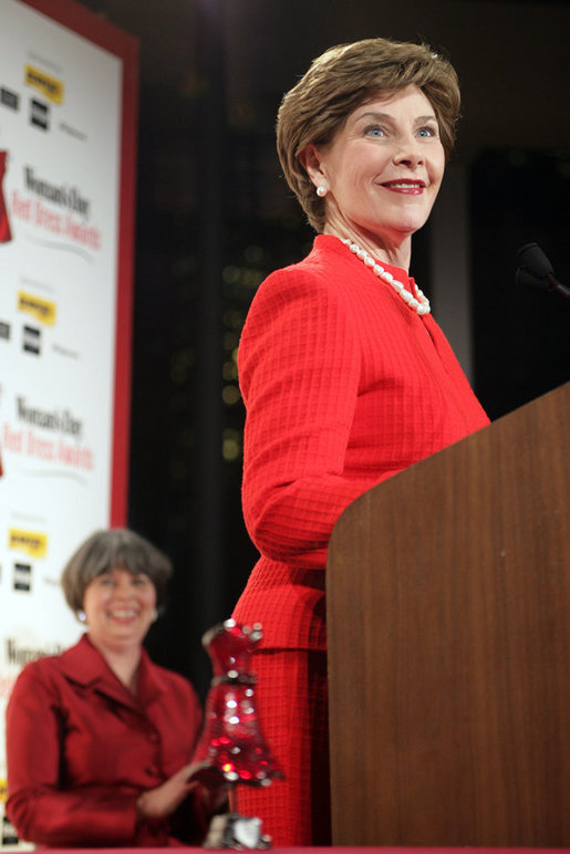 Mrs. Laura Bush accepts the Woman's Day Magazine Red Dress Award in New York, NY for her leadership in raising awareness of women's heart disease, February 1, 2007, as Jane Chestnutt, Editor in Chief of Woman's Day, looks on. White House photo by Shealah Craighead