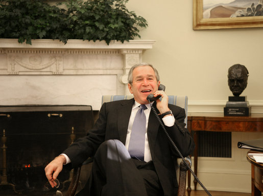 President George W. Bush laughs Monday morning, Feb. 5, 2007, during a phone call from the Oval Office to Jim Irsay, owner of the Super Bowl XLI champion Indianapolis Colts. White House photo by Eric Draper