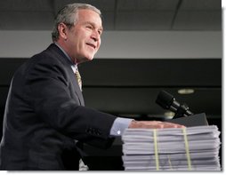 President George W. Bush places his hand on a large stack of legislative earmarks as he addresses the employees at Micron Technology Virginia in Manassas, Va., Tuesday, Feb. 6, 2007, on the economy and fiscal responsibility. President Bush voiced his concern about earmarks being slipped into spending bills saying, “If Congress is genuinely concerned about spending your money wisely, and I believe most members are, then, they must do something about earmarks.” White House photo by Paul Morse