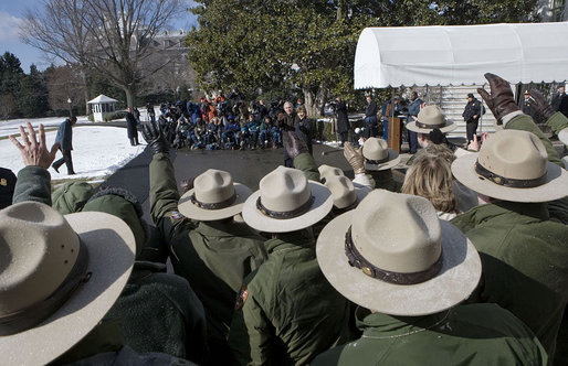 Rangers from the National Park Service wave to President George W. Bush and Laura Bush as they depart for Shenandoah National Park where the President discusses his National Park Centennial Initiative. The Initiative provides for the potential of up to a $3 billion infusion of new funds over the next ten years on top of appropriations for normal operations. "The funding starts with a billion-dollar request over the next 10 years that I'll send up to Congress," said President Bush of the largest ever increase for park operations. White House photo by Eric Draper