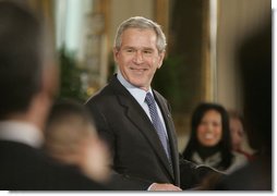 President George W. Bush welcomes guests to the East Room of the White House, Monday, Feb. 12, 2007, for the celebration of African American History Month. White House photo by Paul Morse