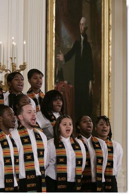 Members of the Jackson High School Black History Tour Group of Jackson, Mich., stand before a painting of George Washington in the East Room of the White House, Monday, Feb. 12, 2007, as they sing during the celebration of African American History Month. White House photo by Paul Morse