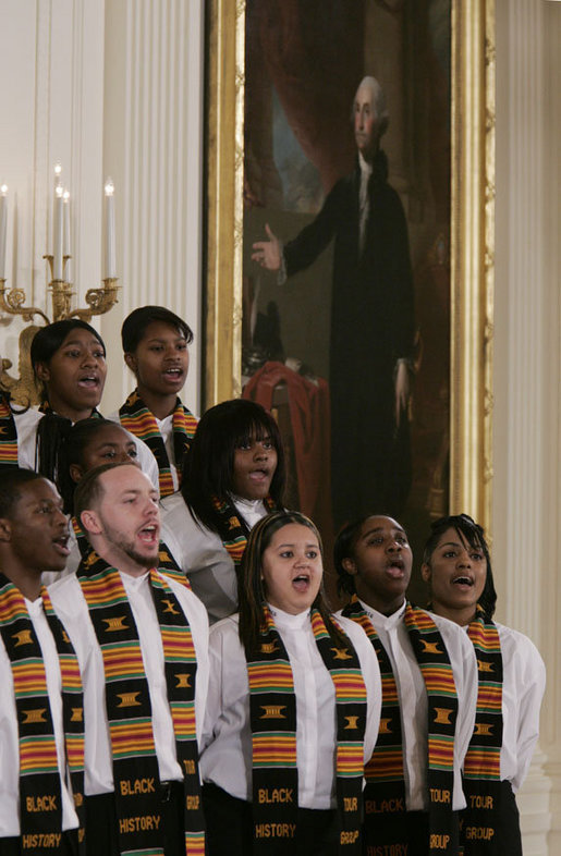 Members of the Jackson High School Black History Tour Group of Jackson, Mich., stand before a painting of George Washington in the East Room of the White House, Monday, Feb. 12, 2007, as they sing during the celebration of African American History Month. White House photo by Paul Morse