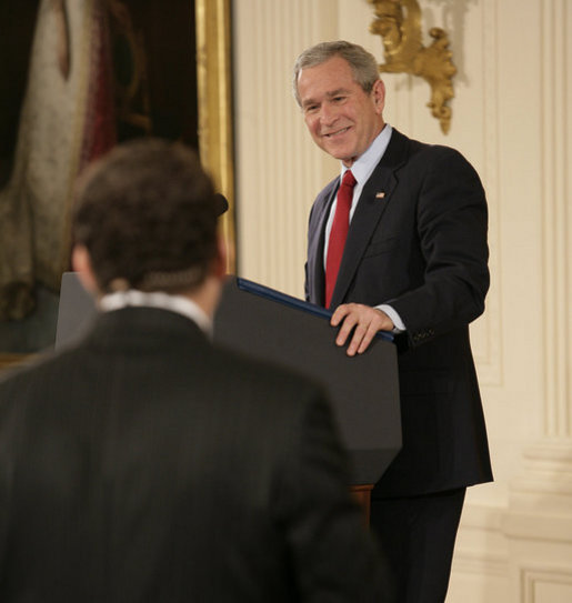 President George W. Bush smiles as he responds to a writer's question Wednesday, Feb. 14, 2007, during a press conference in the East Room of the White House. The President covered many topics including international issues and bipartisan opportunities. White House photo by Eric Draper