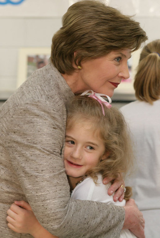 Mrs. Laura Bush receives a farewell hug from a young child at a Boys & Girls Club program Thursday, Feb. 22, 2007 at the D’Iberville Elementary School in D’Iberville, Miss. White House photo by Shealah Craighead