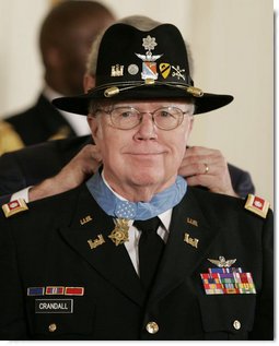 President George W, Bush presents the Medal of Honor to U.S. Army Major Bruce P. Crandall in the East Room of the White House, Monday, Feb. 26, 2007, for his extraordinary heroism as a 1st Cavalry helicopter flight commander in the Republic of Vietnam in November 1965. White House photo by Paul Morse