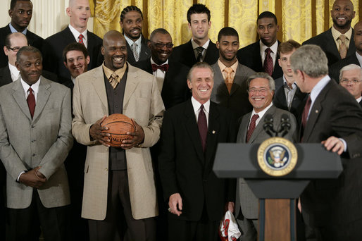 President George W. Bush draws a laugh from the Miami Heat as the 2006 NBA champs visited the White House Tuesday, Feb. 27, 2007. "This is a championship team on the court, and this is a championship team off the court," said the President. "And it is my high honor to welcome them to the White House as NBA champs." White House photo by Eric Draper