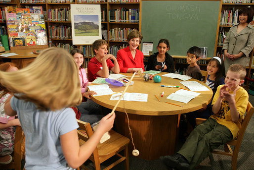 Mrs. Laura Bush watches a student play a ring toss game at Balboa Magnet Elementary School Wednesday, Feb. 28, 2007, in Northridge, Calif., as they participate in Junior Ranger activities. The National Park Service Junior Ranger program provides activities in parks and partnering schools to teach young people about America's National Parks. White House photo by Shealah Craighead