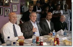 President George W. Bush is joined by New Orleans Mayor Ray Nagin, Louisiana Lt. Gov. Mitch Landrieu, left, and New Orleans Archbishop Alfred Hughes, right, Thursday, March 1, 2007 in New Orleans, during a luncheon with elected officials and community leaders on the recovery progress of their Gulf Coast region. White House photo by Eric Draper