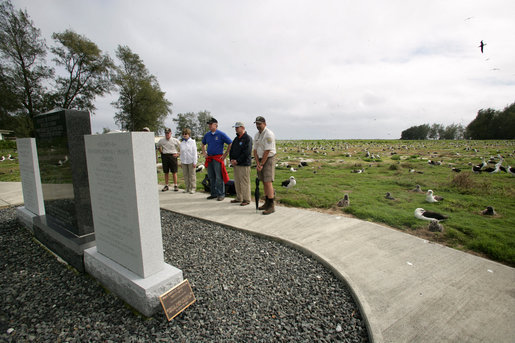 Mrs. Laura Bush visits the Battle of Midway Memorial on the parade grounds of Midway Island Thursday, March 1, 2007. Midway Atoll was the site of the World War II battle June 4, 1942. The U.S. Navy defeated a Japanese attack against Midway Islands, marking a turning point in the war in the pacific theater. Interior Secretary Dirk Kempthorne is pictured wearing a blue shirt and is standing next to Mrs. Bush. White House photo by Shealah Craighead